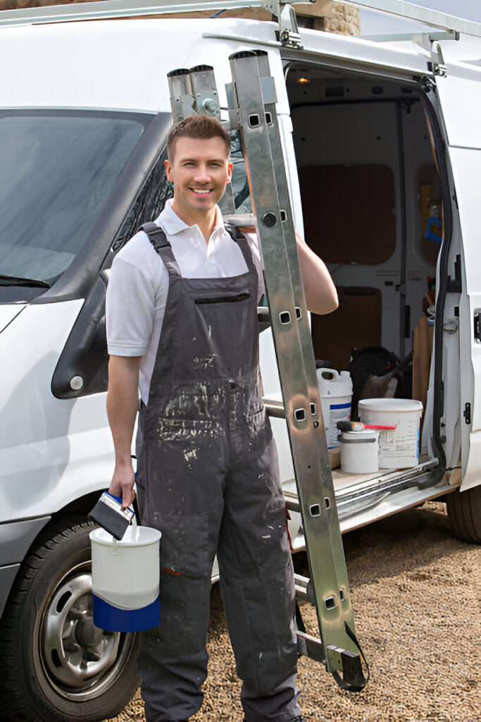 Professional painter standing in front of a work van, holding a ladder and paint bucket, wearing overalls and ready for a painting job.