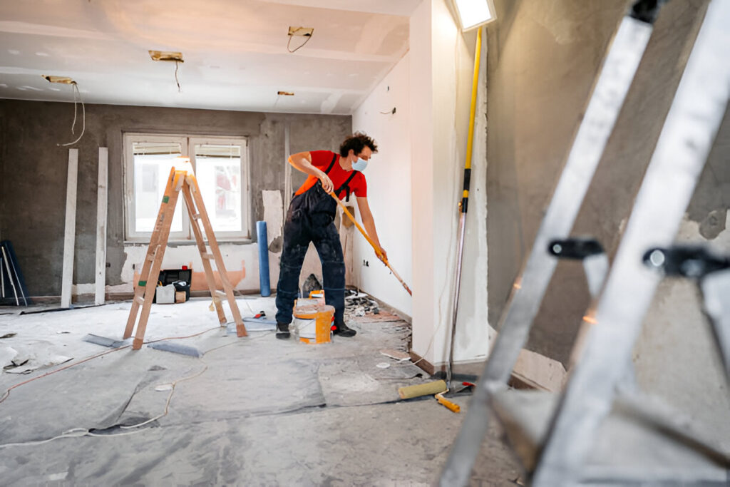 A man painting the interior wall.