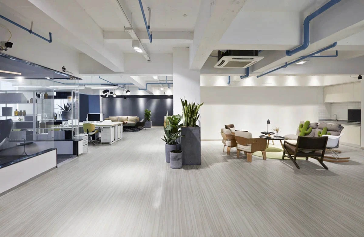 Open-plan modern office space with various seating areas and workstations.