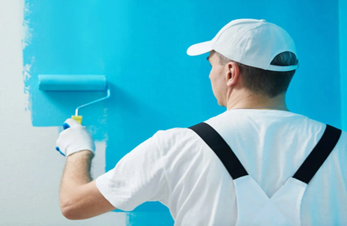 Service Hub painter rolling a fresh coat onto a wall