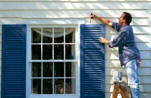 A Person Exterior Painting in Damac Hills window in the give the services by hub services in duabai dama's.